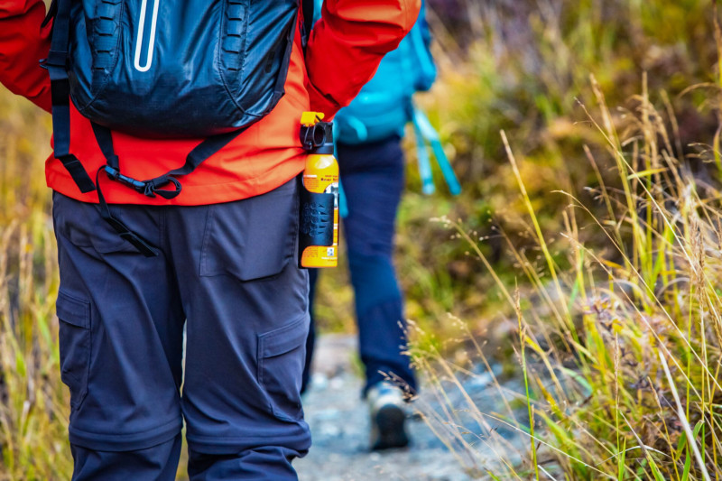 Bear spray self-defence attached to backpackers when hiking