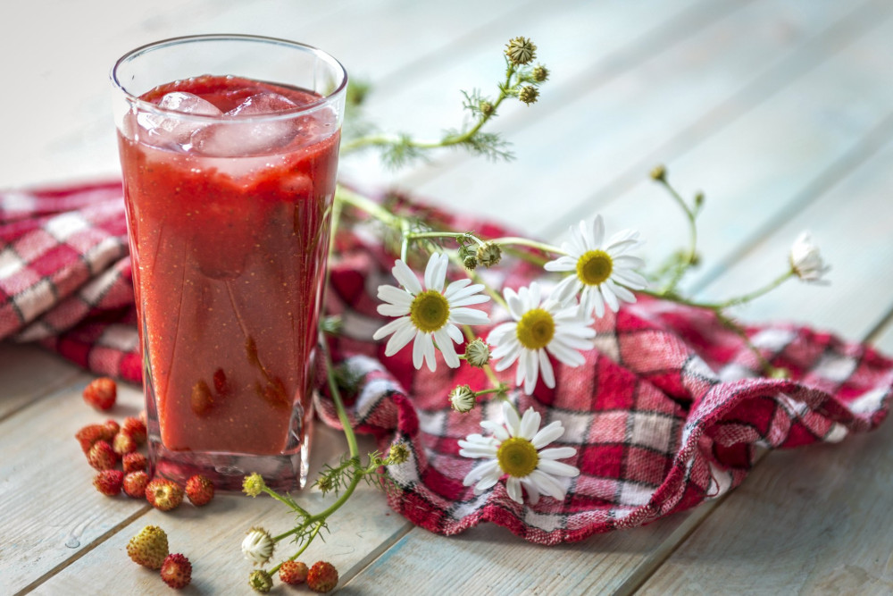 Big glass of homemade smoothie with strawberries