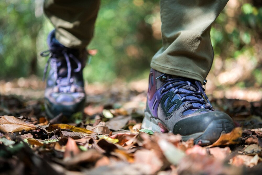 Close up of man feet while hiking in nature.