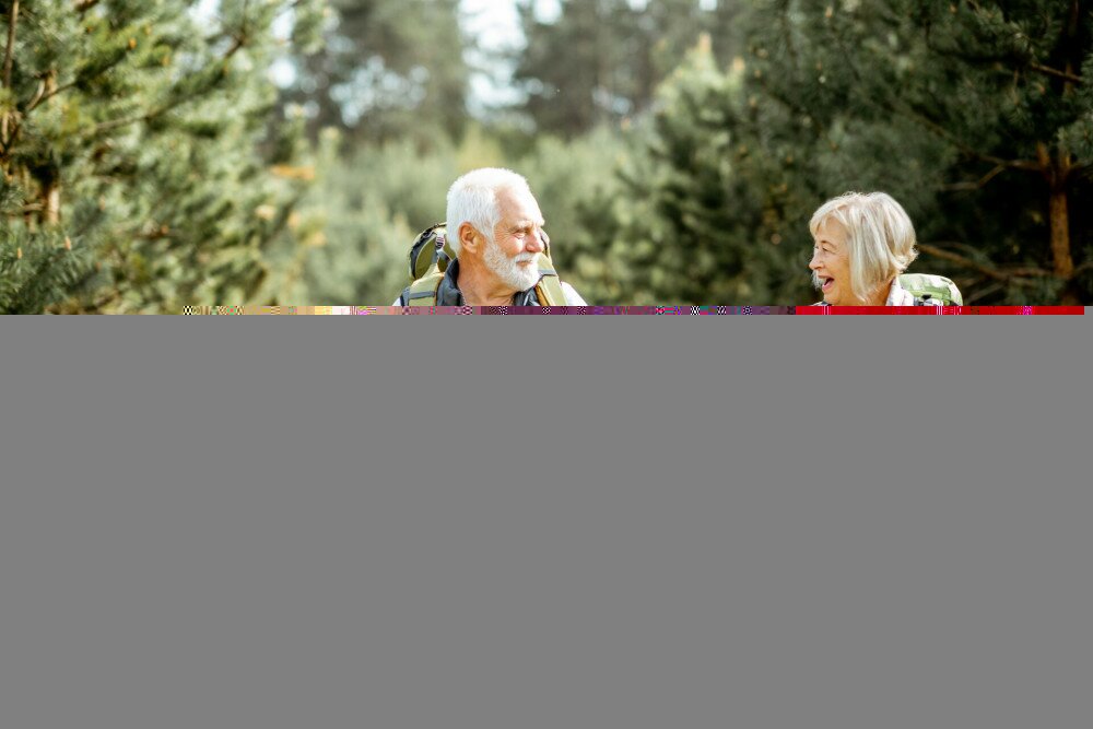 Senior couple hiking in the forest