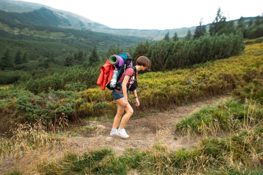 woman goes hiking with a backpack, mountains, nature, travel