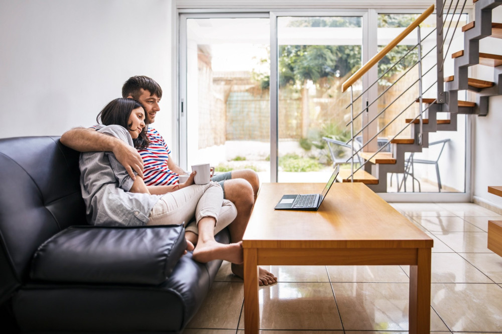 Young couple relaxing and watching movie at home. family concept